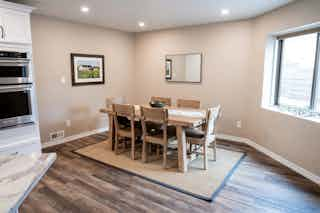 A photograph of an updated dining room with new wooden floors by Homefix of Colorado Springs