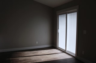 Remodeled dining room with sun shining through the doors.