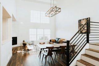 A photograph of a renovated great room in a minimal white style in Colorado Springs