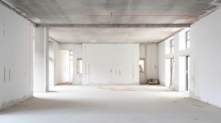 A photograph of an empty room in the process of being remodeled