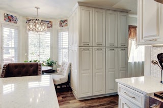 A photograph of custom built and installed white cabinets added to a kitchen remodel completed by Homefix in Colorado Springs