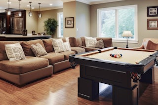 A photograph of a walkout basement entertainment / game room in Colorado Springs