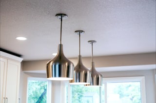 A photo of 3 lights with custom electrical routing in a remodeled kitchen
