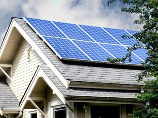 A photograph of solar panels that installed on top of a house in Colorado Springs