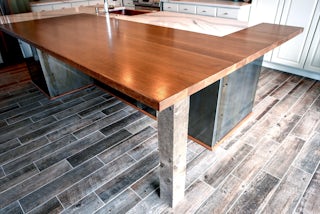 A close up photo of the natural wood breakfast bar / kitchen island in a new kitchen remodel located in Colorado Springs