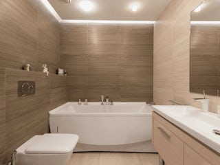 A modern bathroom remodel with tan walls, a big bath tub and neutral color tones